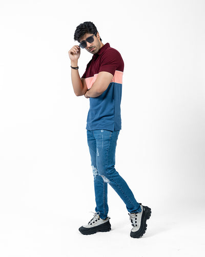 model wearing mens color block polo shirt with blue jeans