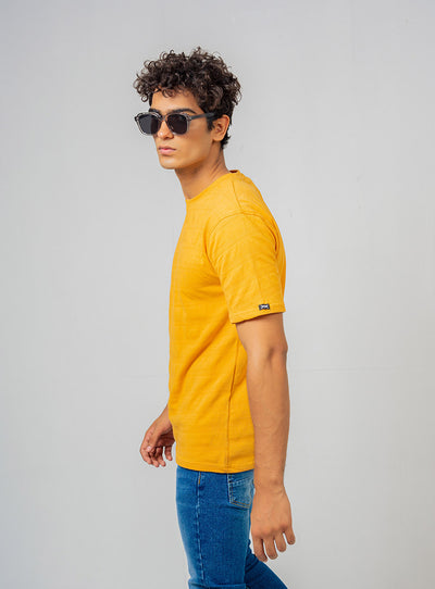 side of the mustard color shirt worn by a model